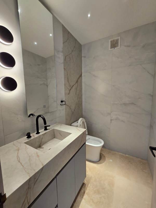 Bedroom with large window ocean view, TV, wood panel wall in PH Q Tower Punta Pacifica