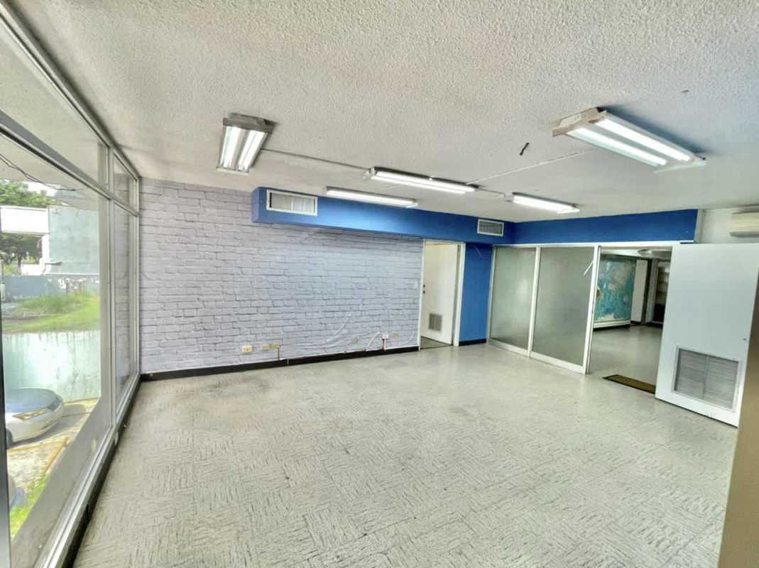 Private enclosed office with glass wall and built-in shelving in PH Virrey Panama