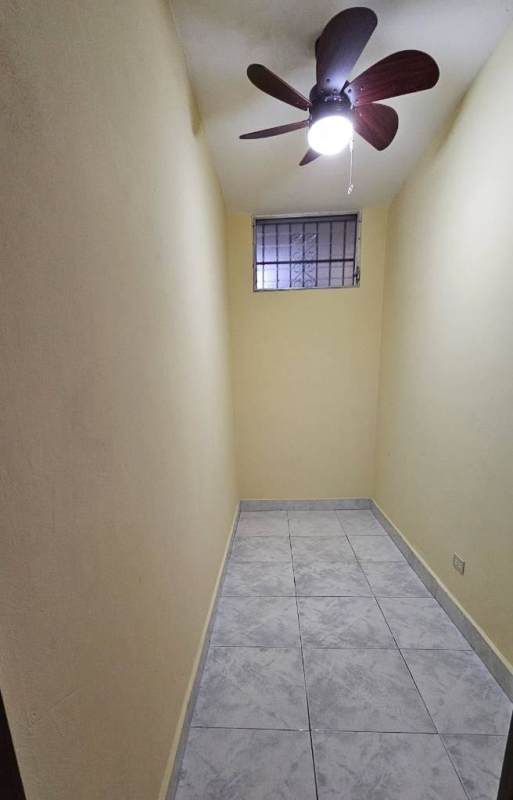 Living room or hallway with ceiling fans, arch niche and tiled flooring in Betania Panama apartment