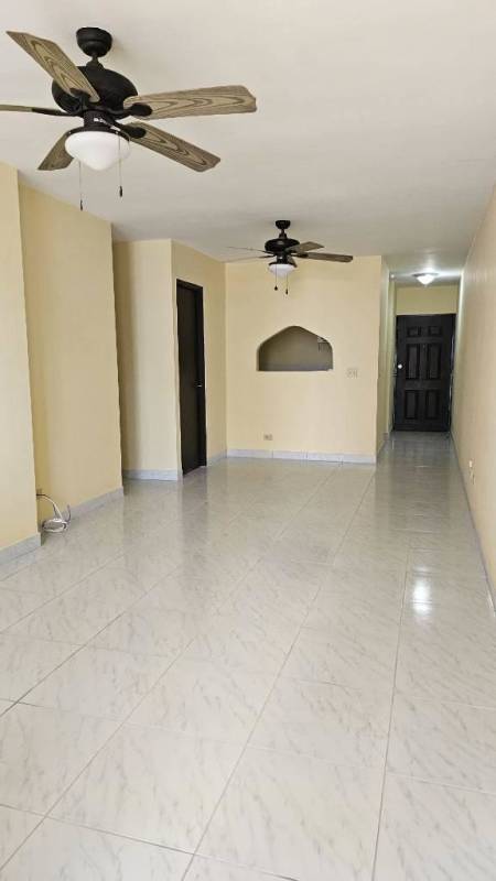 Second bedroom with two glass louver windows, tiled floor, light yellow walls in Betania Panama
