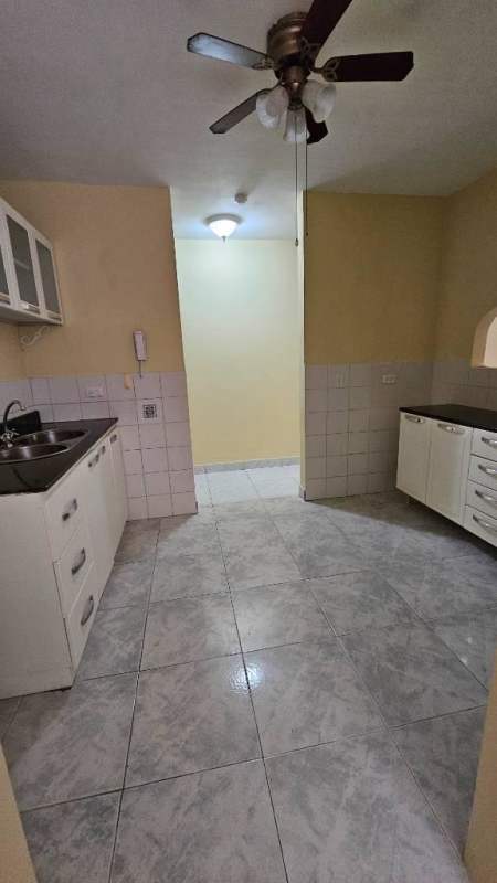 Bright apartment hallway with yellow walls, security door and art decor in Betania Panama