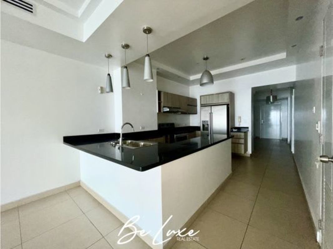 Contemporary kitchen with granite countertops and island in luxury PH Rivage apartment Panama City