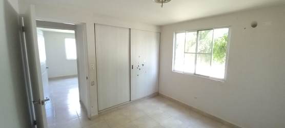 Bedroom with bright window built-in closet tile floor at Playa Dorada Vacamonte Panama