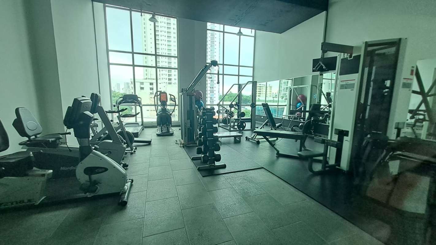 Modern gym with equipment and windows PH Quartier San Francisco Panama