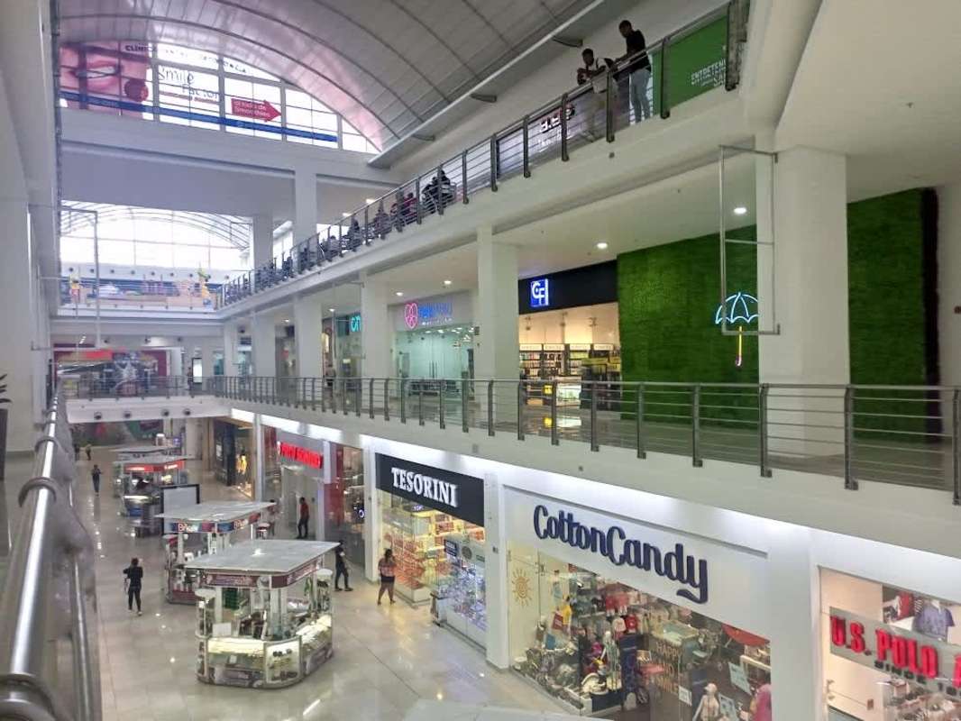 Interior atrium with multiple retail stores and kiosks inside Los Andes Mall Panama