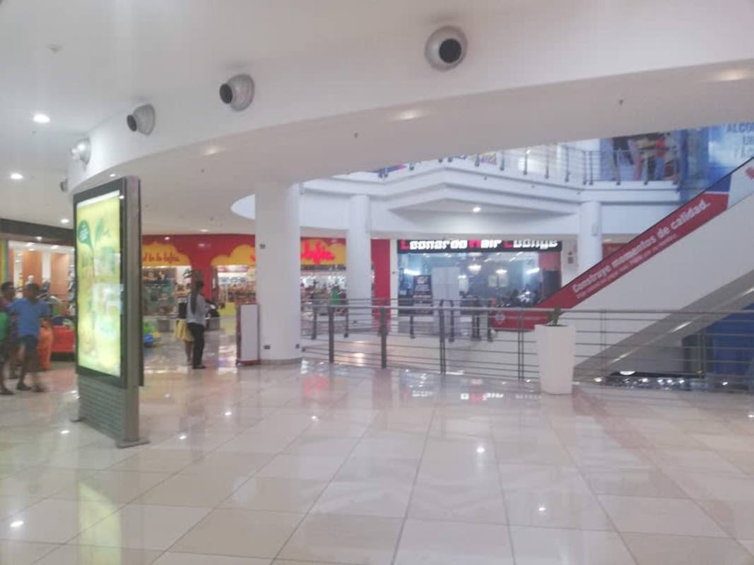 Wide commercial area with shops, escalator in Los Andes Mall Panama