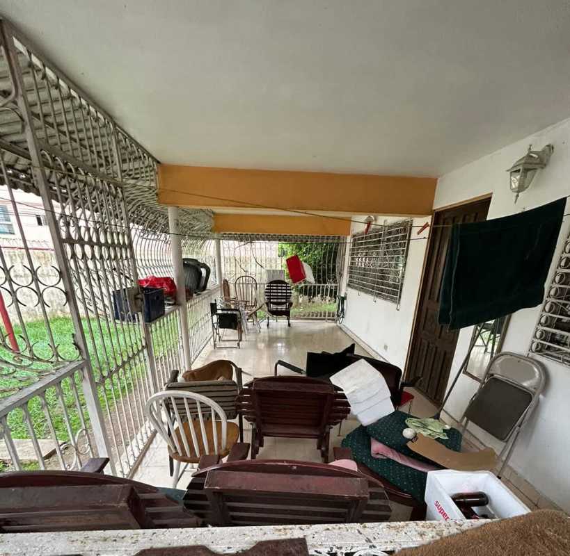 Porch area with metal bars and assorted chairs secure outdoor space Chanis Panama house