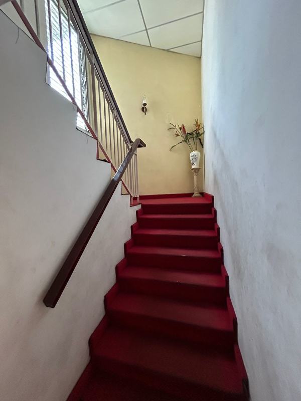 Two-story house exterior with garden fence balcony in Chanis Panama Family Home