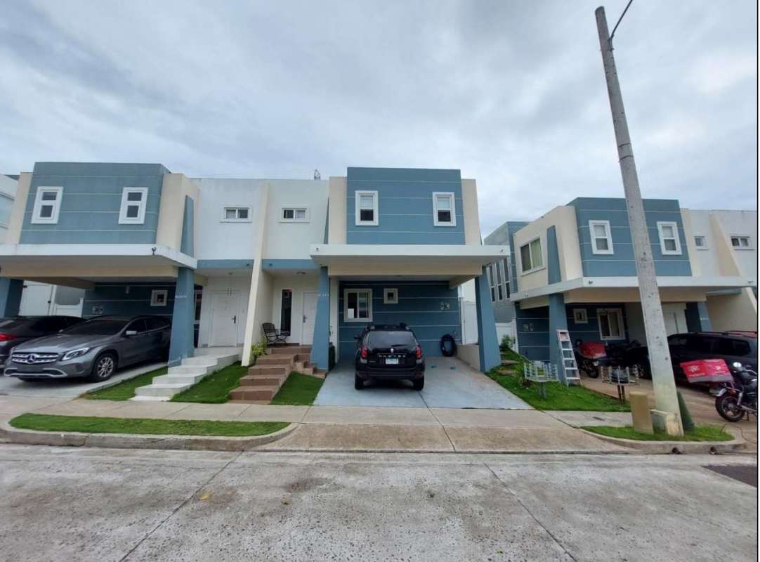 Modern two-story townhouse row with carports and lawn in Brisas del Golf Panama