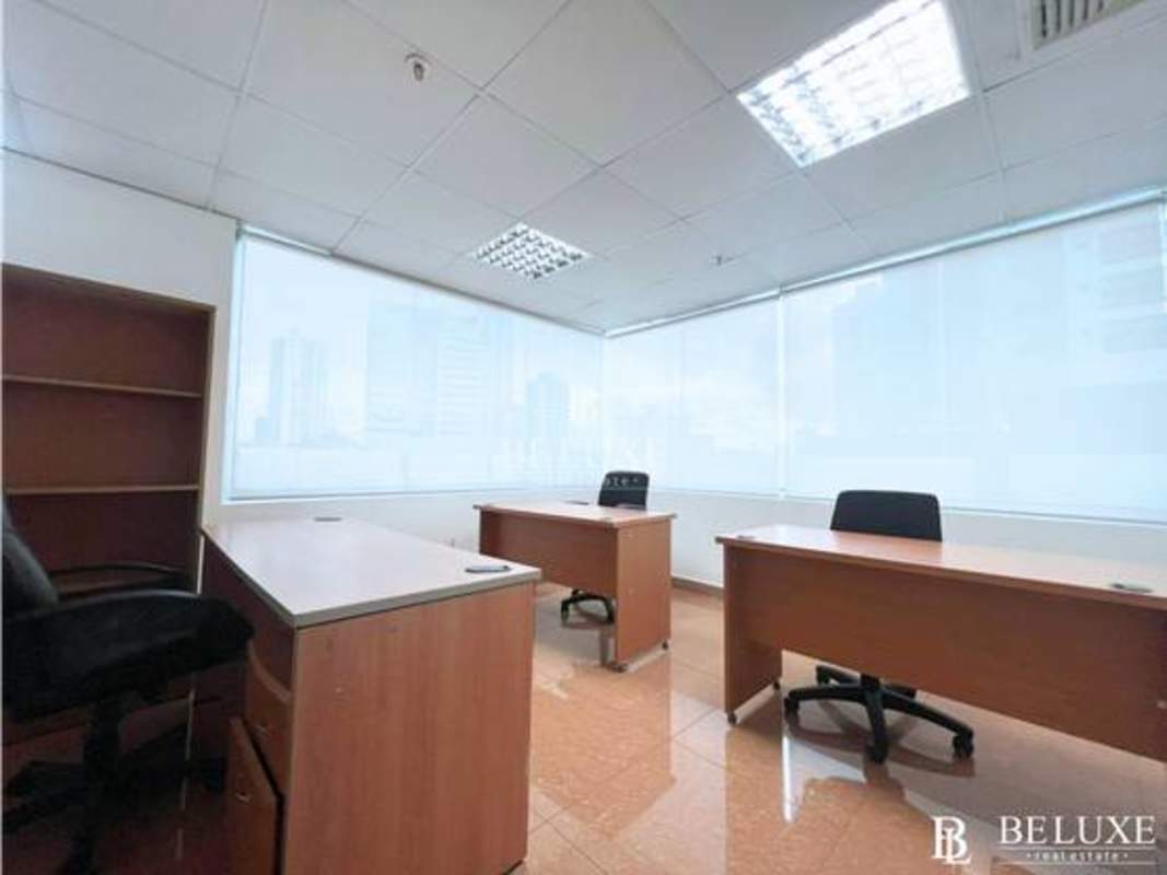 Office interior with multiple desks, shelves, modern lighting at PH Centro Financiero El Carmen Panama