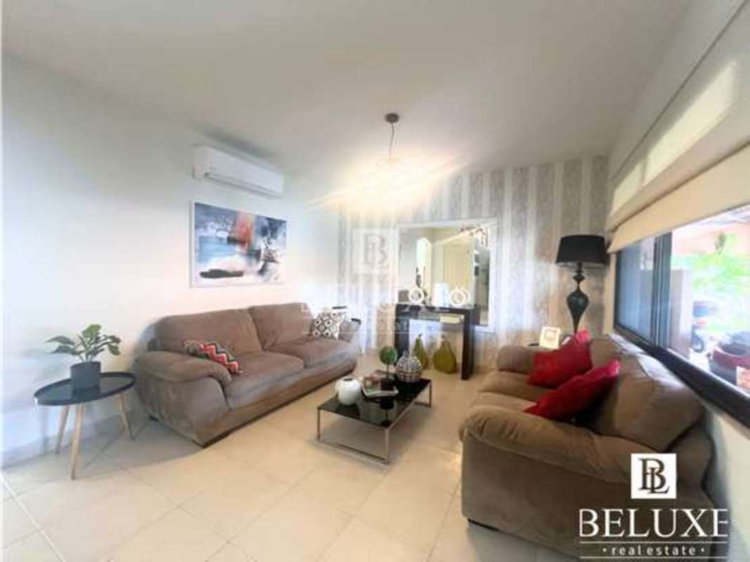 Remodeled kitchen with granite countertops and wooden cabinetry at PH Versalles Panama City for sale