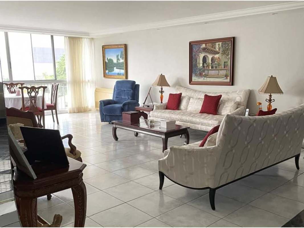 Traditional living dining room with cream sofas, large window, tiled floor, and natural light at PH Fiesta Obarrio