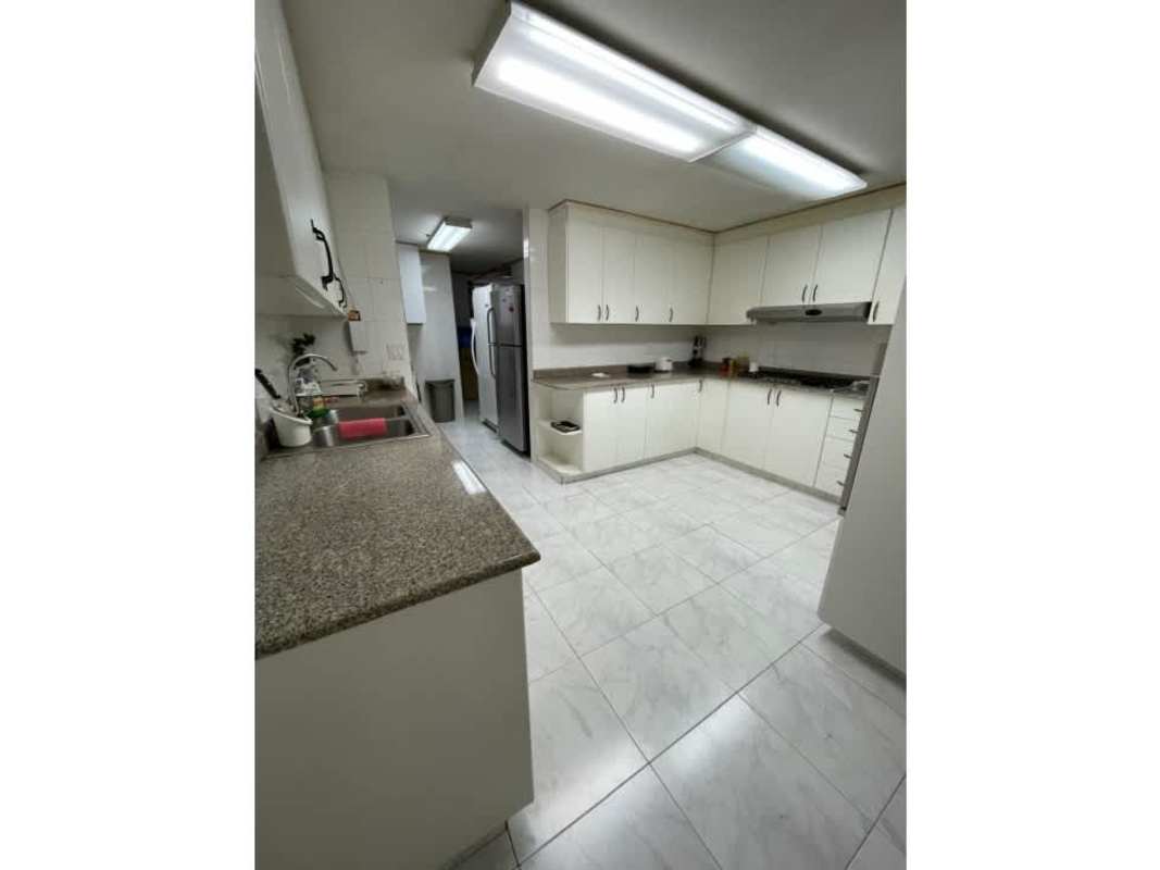 Modern kitchen with white cabinets, granite countertops, stainless appliances PH Fiesta Obarrio