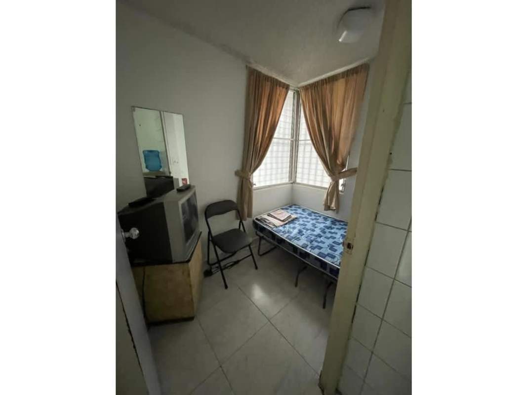 Compact bedroom with windows, curtain, CRT TV and tile floor Fiesta Obarrio Panama