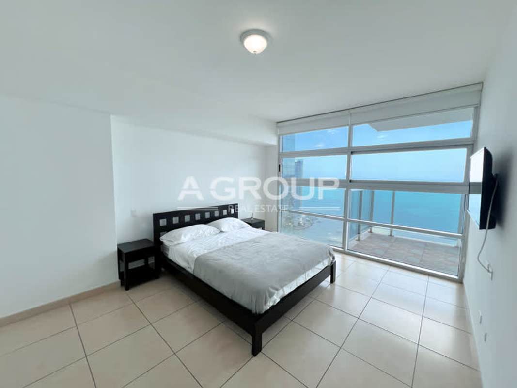 Minimalist second bedroom with large window and city skyline view in Waters on the Bay Avenida Balboa Panama