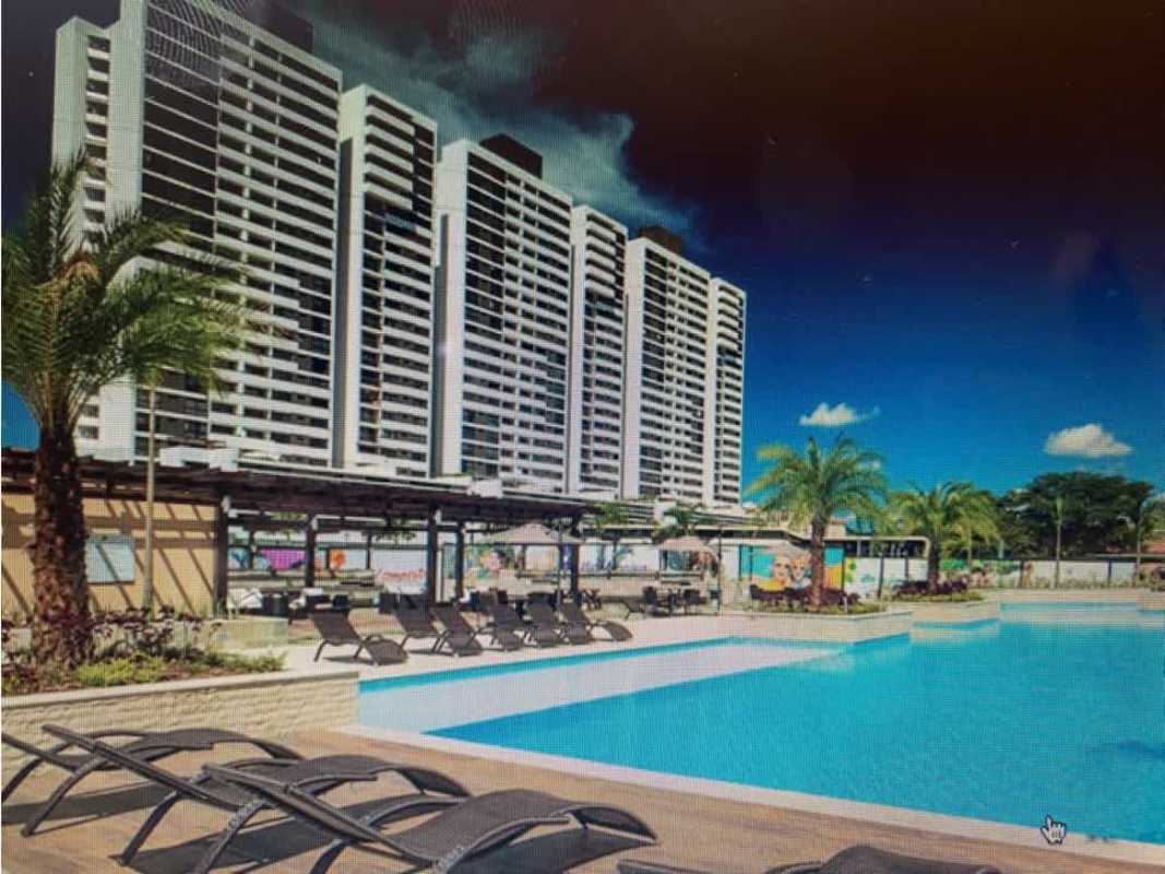 Outdoor swimming pool with lounge chairs at PH Country Club residential complex Panama City