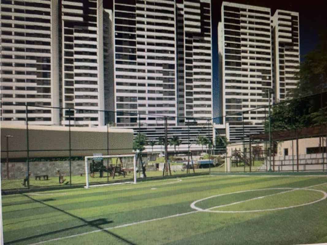 Modern apartment towers with fenced soccer field playground PH Country Club Condado del Rey