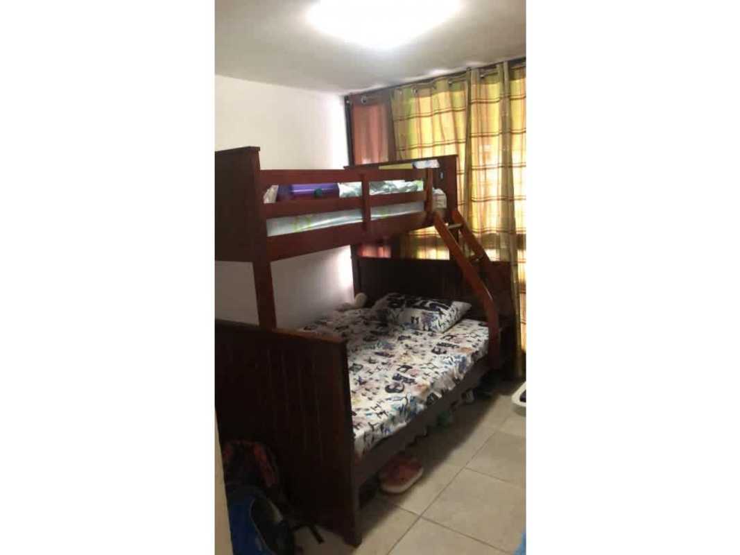Small bedroom with wooden bunk beds and curtains PH Country Club Condado del Rey Panama