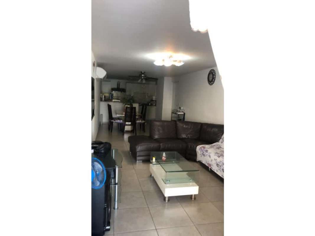 Spacious living and dining area with sofa and open kitchen at PH Country Club Condado del Rey, Panama