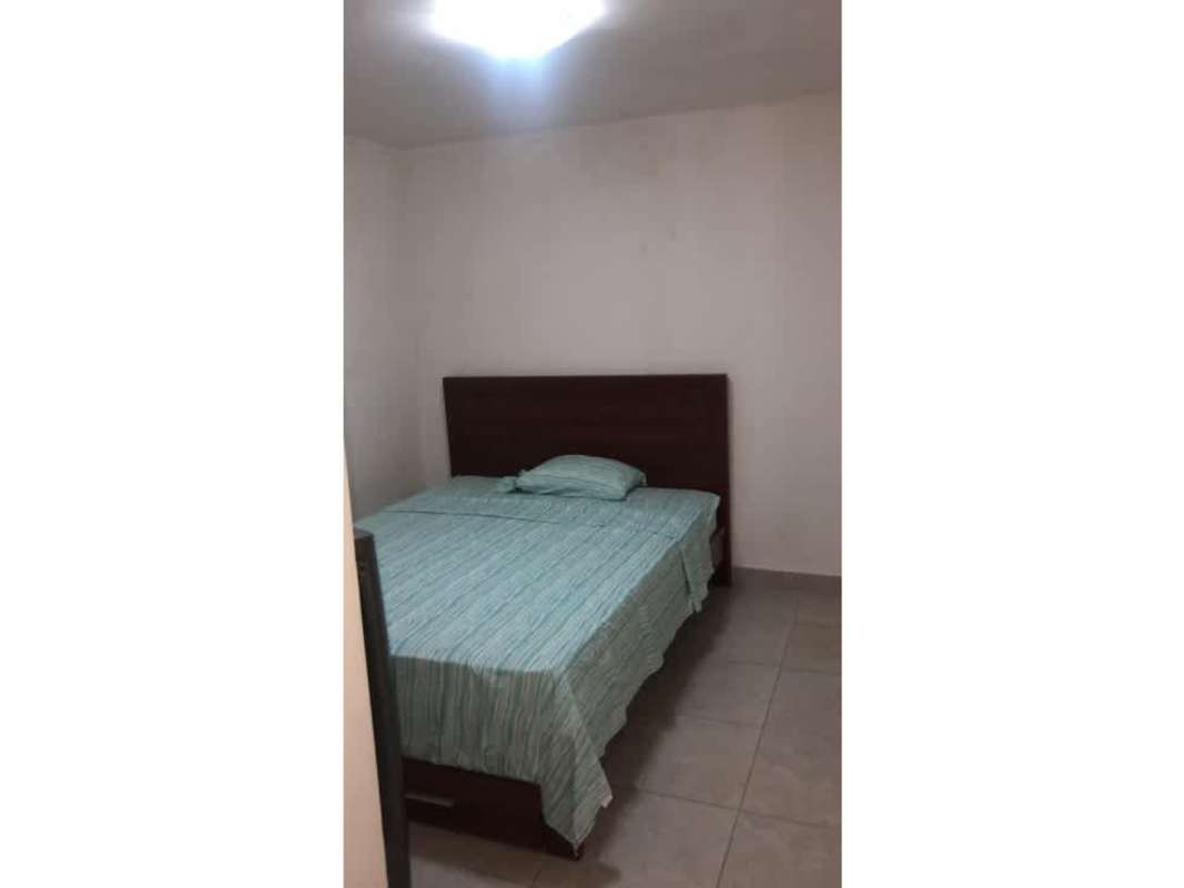 Minimalist bedroom with white walls and double bed in PH Country Club Condado del Rey Panama