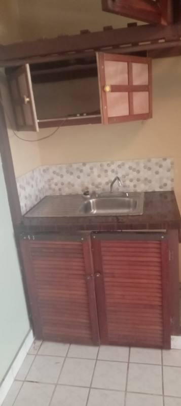 Rustic-style kitchen with wooden cabinets, mosaic backsplash in house El Crisol