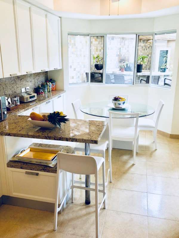 Backyard pool with waterfall, seating area, covered bohio in Costa del Este Panama