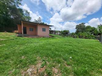 Pink single-story house with large grassy garden in La Chorrera Panama
