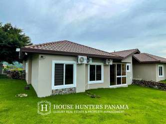 Modern bathroom with glass shower enclosure, tile walls in Boquete Canyon Village home for sale
