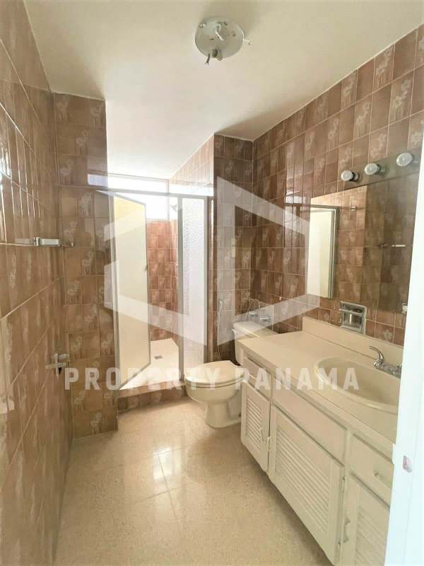 Large living room area with windows showcasing city skyline views in PH Savoy Punta Paitilla Panama City