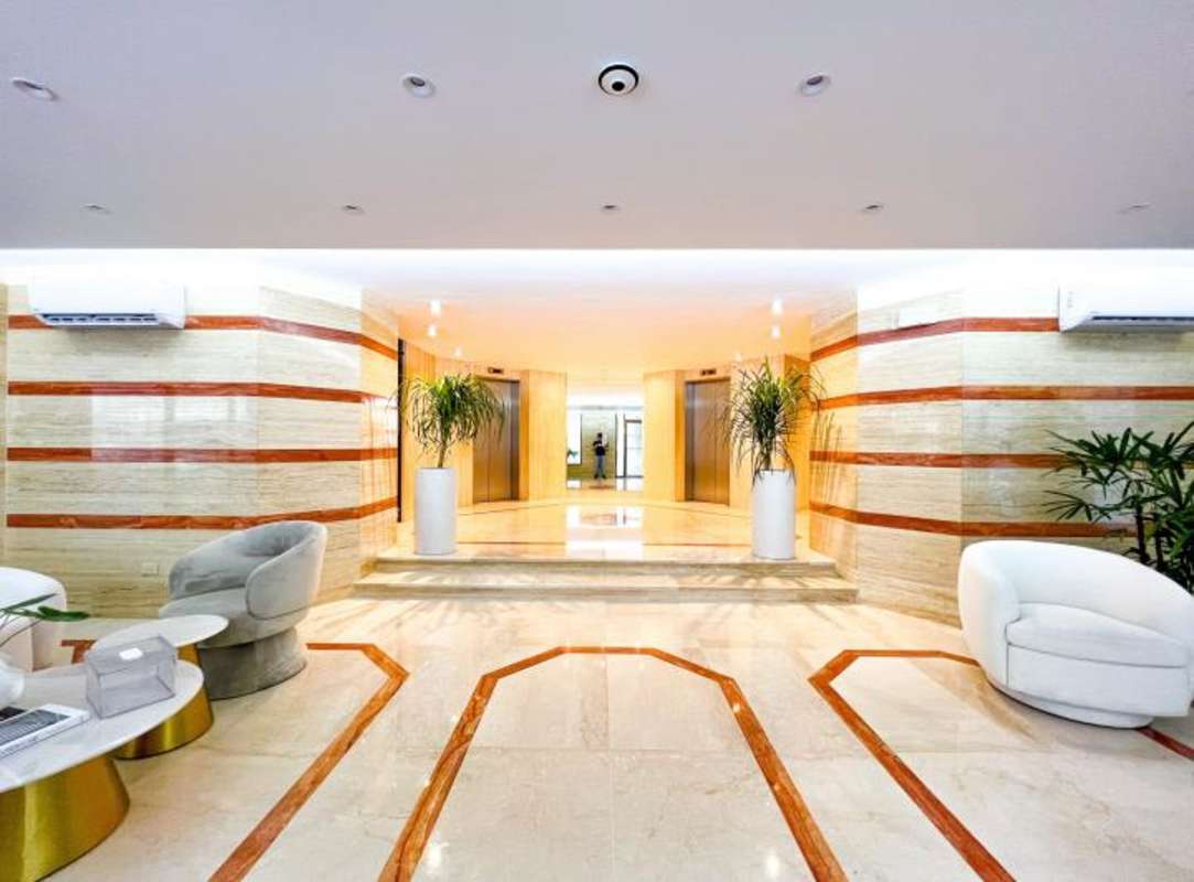 Aerial view of PH Crillon tower, coastal condos, and ocean in Punta Paitilla Panama