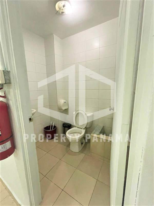 Commercial unit bathroom with tiled walls, ceramic fixtures and minimalist design in Albrook Mall Panama