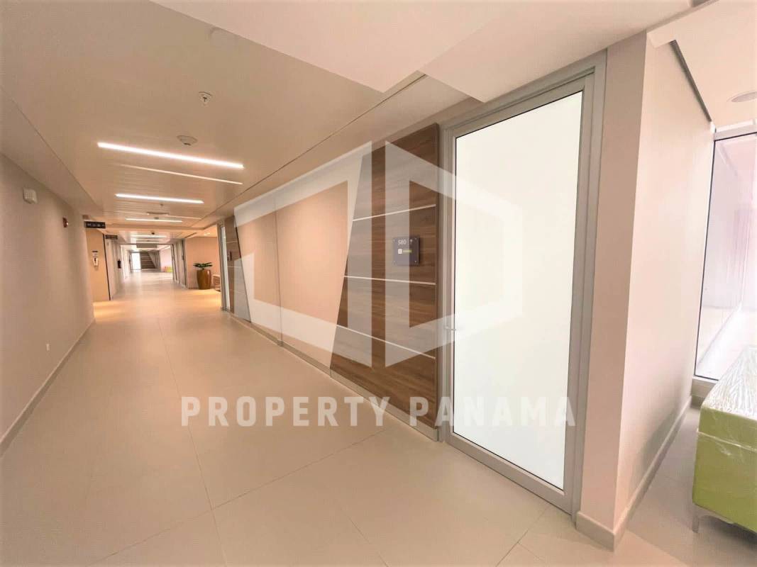 Office corridor with frosted glass door, modern lighting at Town Center Costa del Este Panama