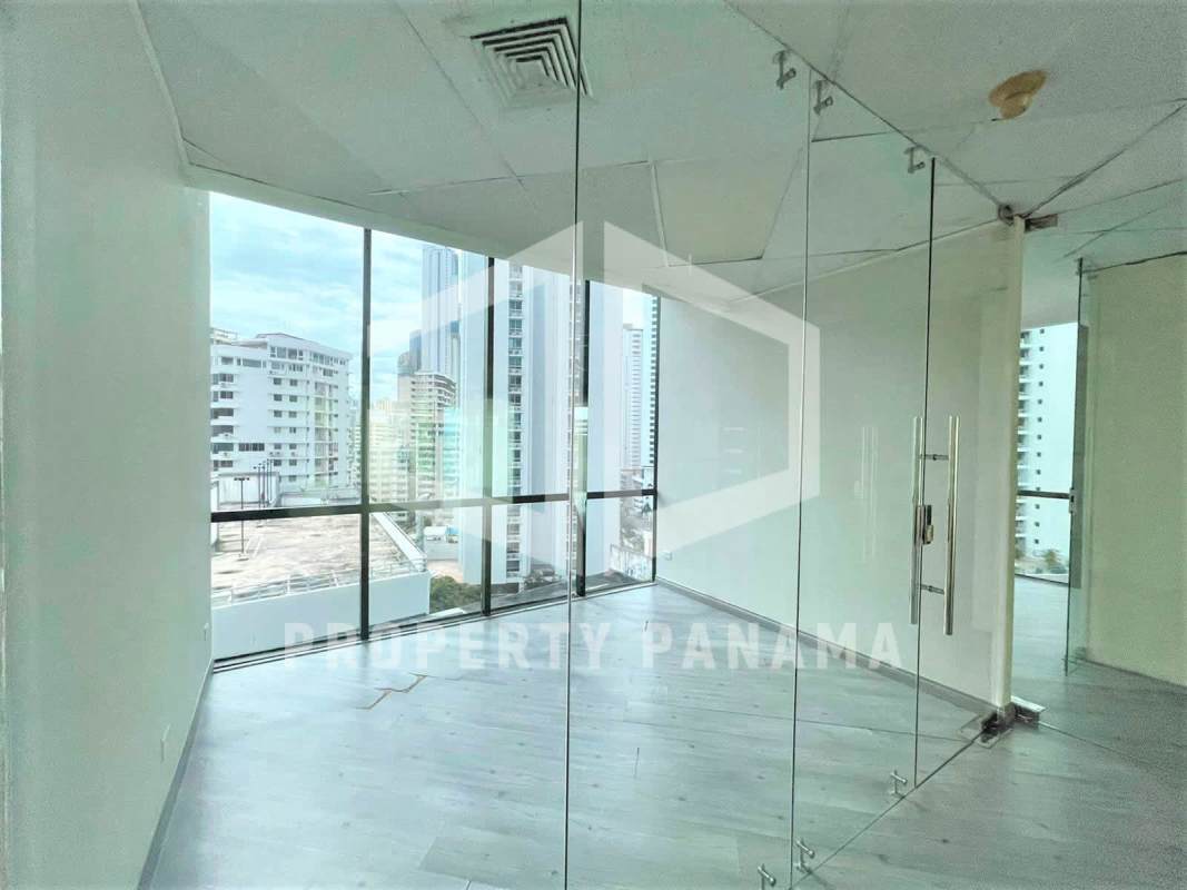 Bright corner office with floor-to-ceiling windows panoramic ocean and skyline view Torre Banco General Panama City