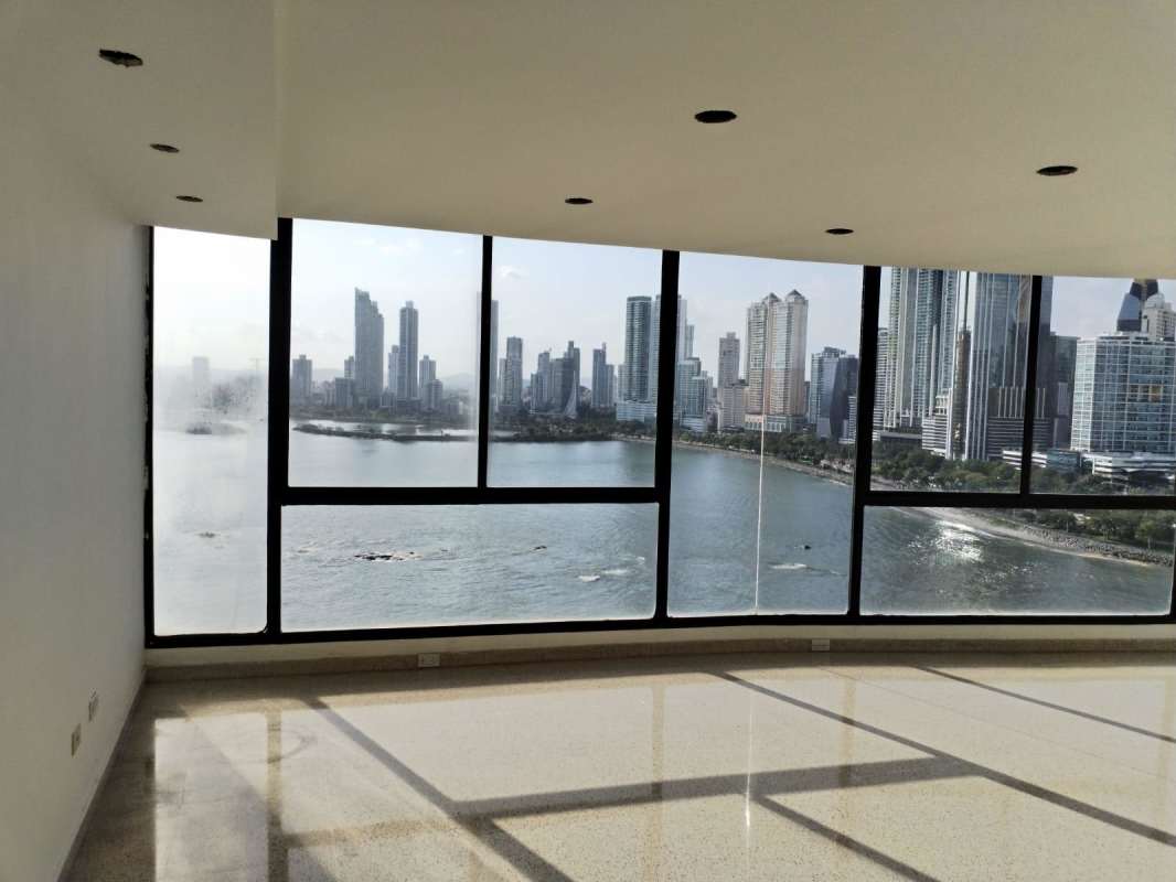 Panoramic coastal view of Panama Bay and skyline visible through floor-to-ceiling windows