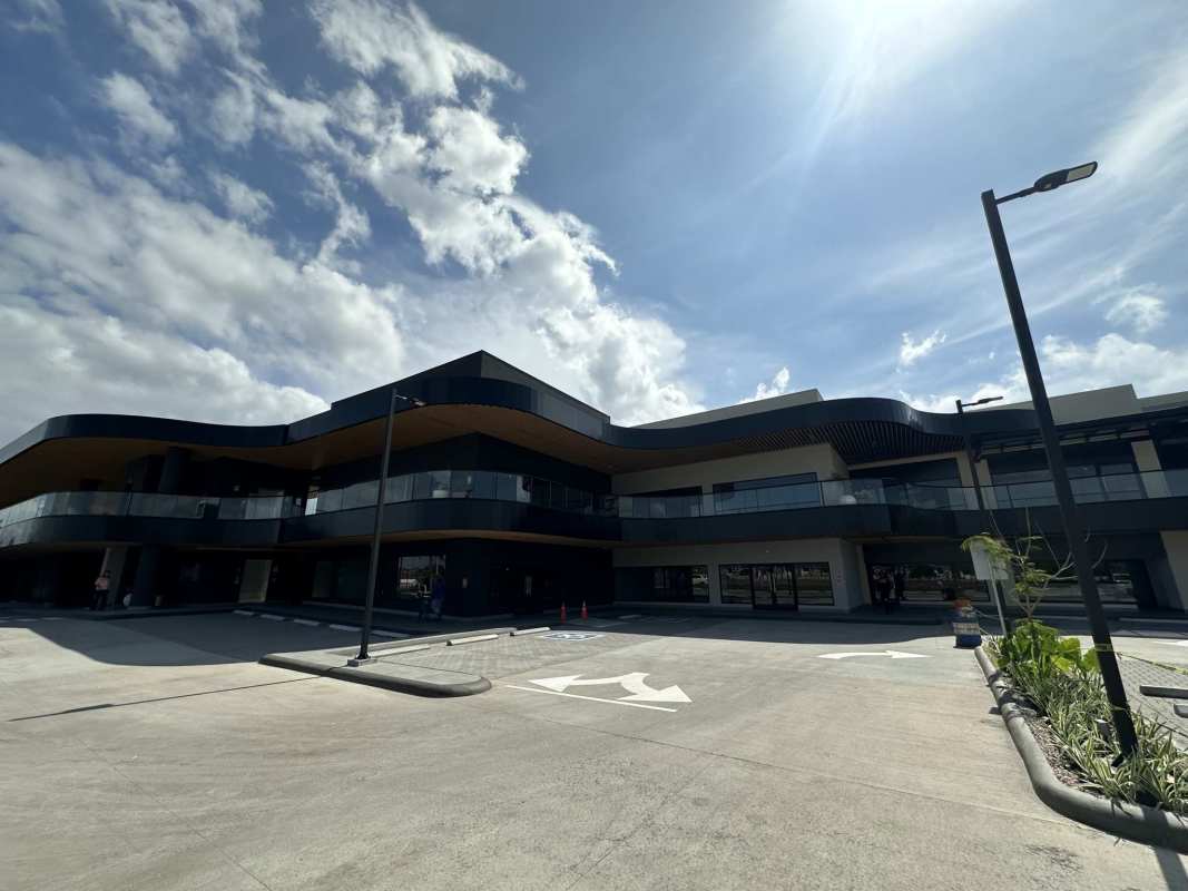 Commercial mall Paseo Drive with curved design large parking and glass facade Panama