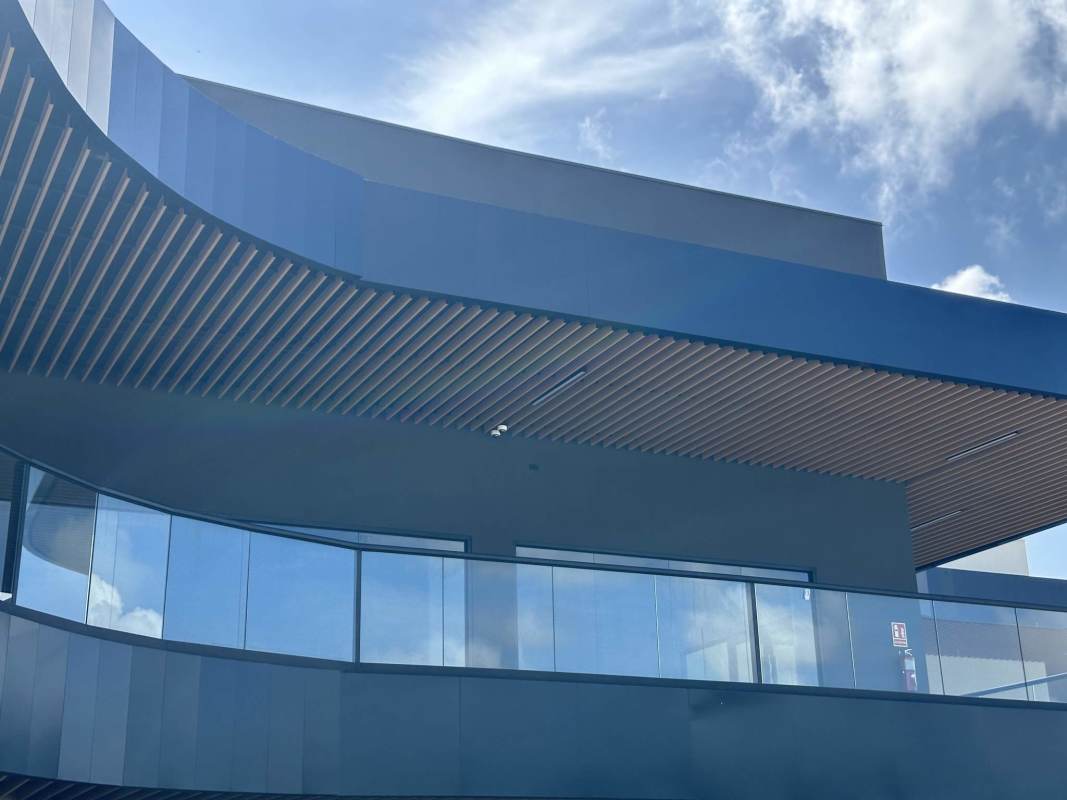 Curved glass balcony and facade of Paseo Drive Plaza commercial building Panama