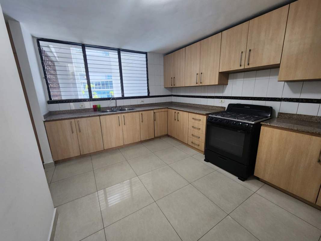 Dining space with ocean and skyline panorama through large window PH Miramar Panama