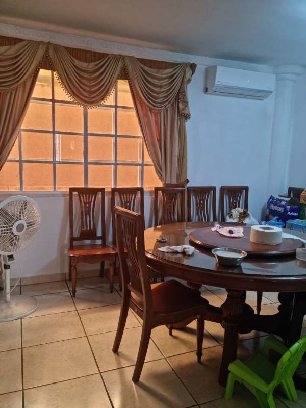 Modern bathroom with vessel sink, granite countertop, glass shower enclosure in family house Panama