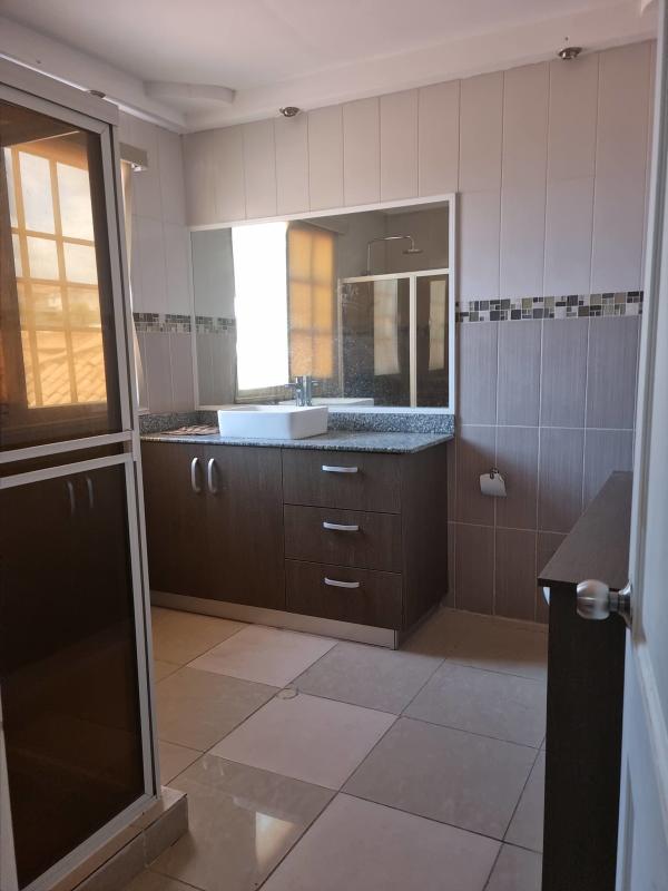 Elegant living room with wood floor, chandeliers, large windows in house Brisas del Golf Panama