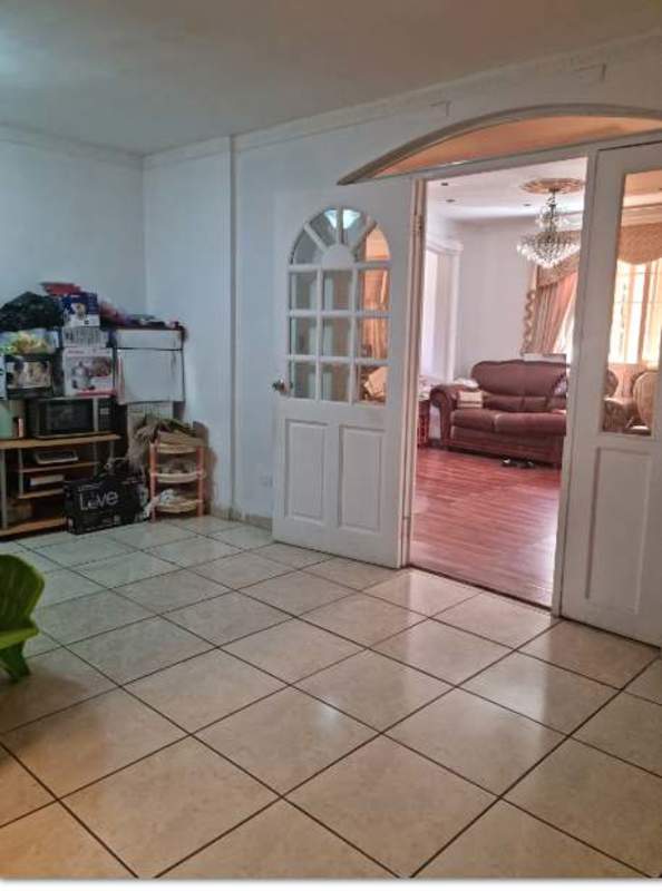 Balcony with decorative railing overlooking Panama city skyline and mountains in Brisas del Golf Panama