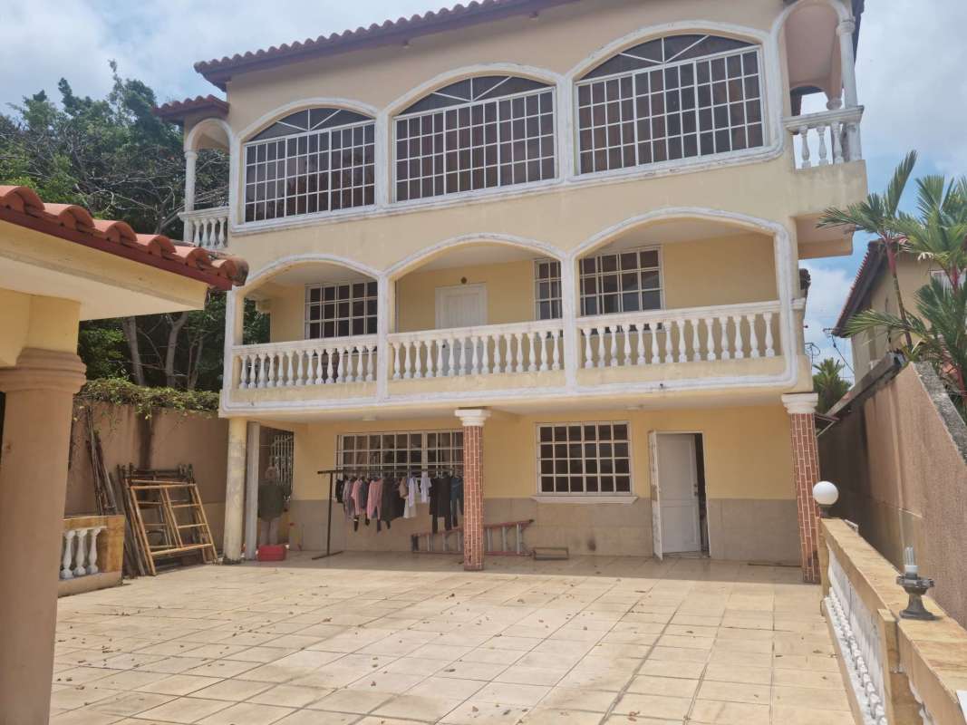 View of tiled hallway opening into living space with wood laminate floor in house at Brisas del Golf Panama
