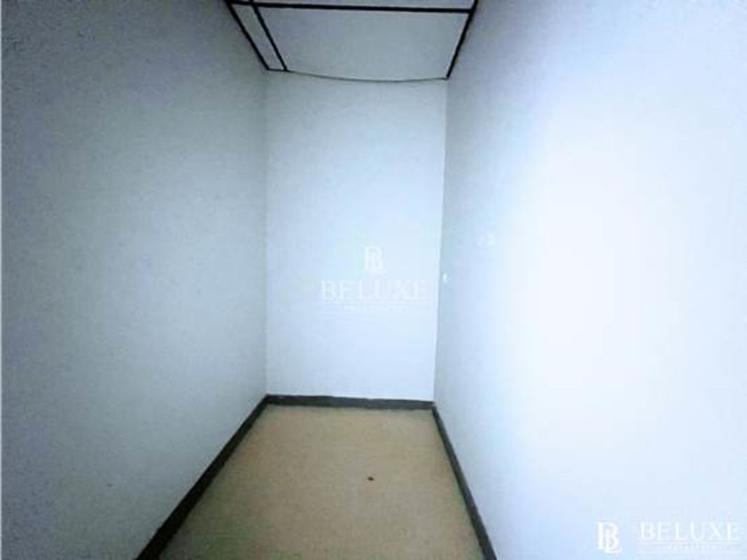 Compact storage area with white walls and tile floor within office space PH El Dorado Panama