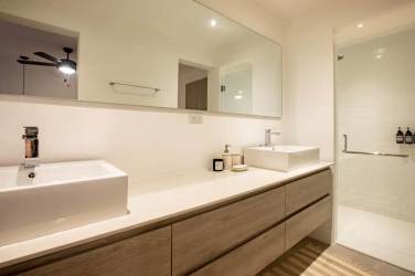 Open plan living dining with sofa, wood table, ceiling fan, Blue Venao Playa Venao Panama