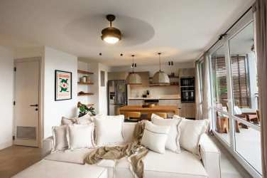 Modern minimalist master bedroom with king bed, woven lights, ceiling fan, large window Playa Venao Panama