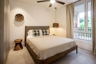 Modern bathroom with double sink, large mirror, glass walk-in shower at Blue Venao condo