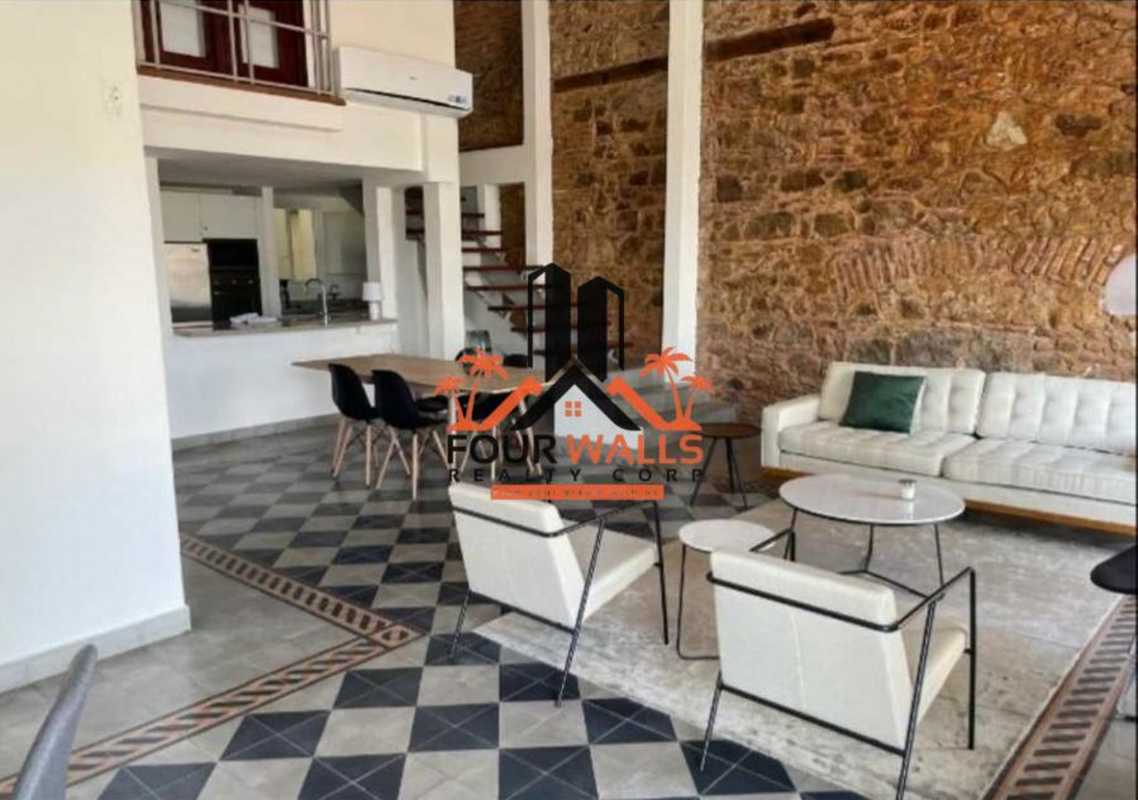 Living dining with mezzanine, exposed stone, stylish furnishings in PH Casa Episcopal Casco Viejo