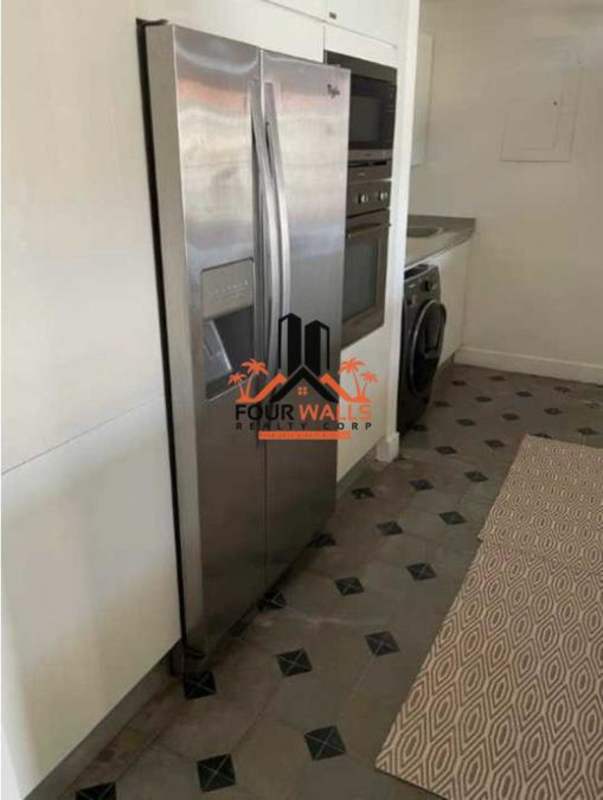 Modern kitchen with stainless steel refrigerator, washer-dryer, tile floor Casco Viejo