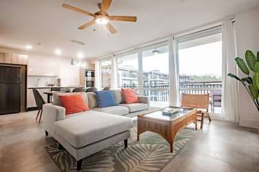 Living room with sectional sofa, dining area, open concept layout at Playa Venao Condo