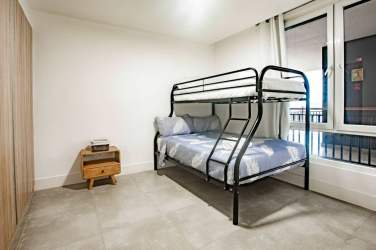 Bedroom with king-size bed, large windows with garden views, ceiling fan at Blue Venao Panama