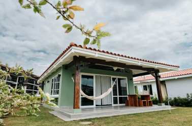 Coastal open living-dining area with turquoise accents at Blue Venao villa Panama